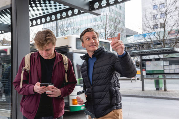 istock Father and son waiting for their bus on a bus station 1393663077