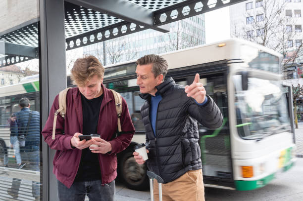 istock Father and son waiting for their bus on a bus station 1393663152