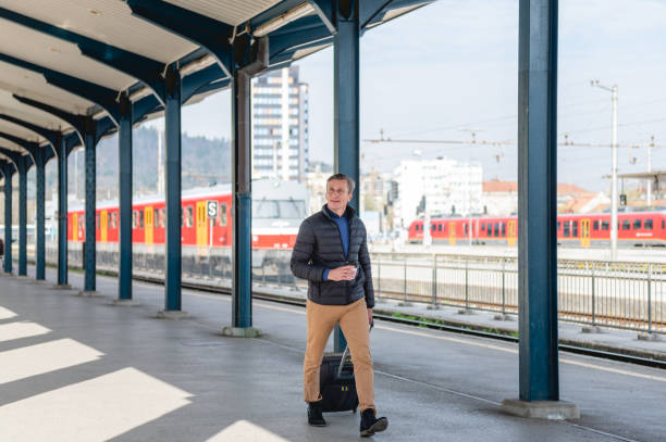 istock Caucasian mature man catching a train at a train station 1393663357