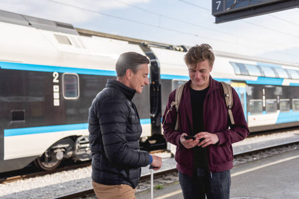 istock Father And Son Waiting For Their Train on a Train Platform 1393663392