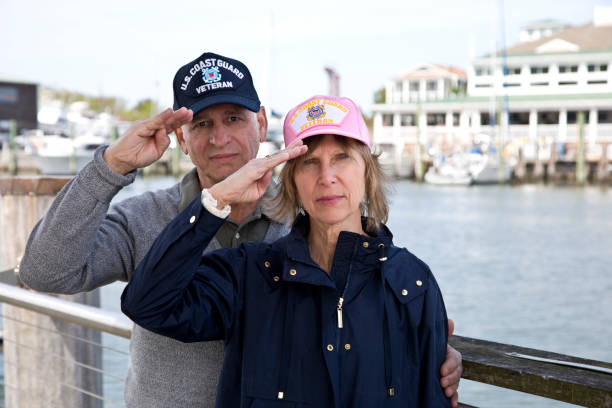 istock U.S. Coast Guard Veterans wearing caps saluting looking at camera 1393663442