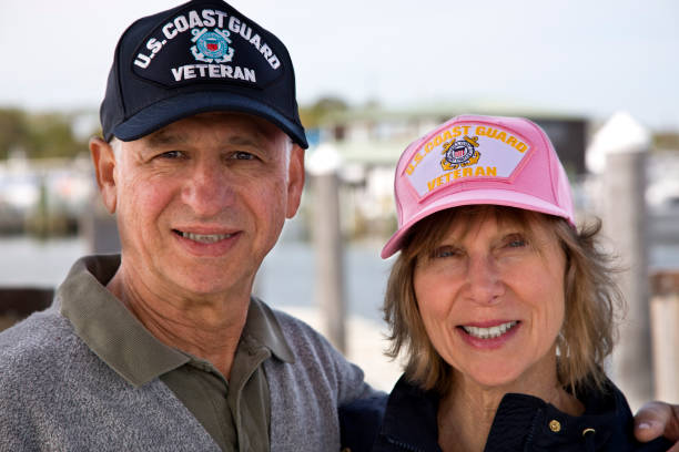 istock U.S. Coast Guard Veterans wearing caps smiling looking at camera 1393663446
