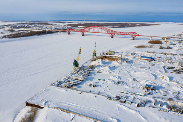 Khanty-Mansiysk in winter. The Irtysh River and berths. The Red Dragon Bridge. Aerial view. stock photo