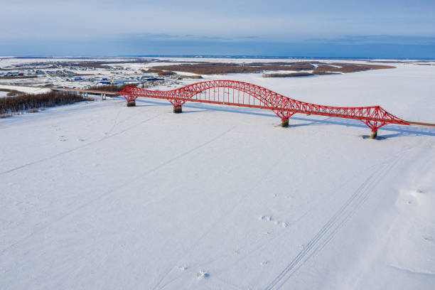 Khanty-Mansiysk in winter. The Irtysh River and berths. The Red Dragon Bridge. Aerial view. stock photo