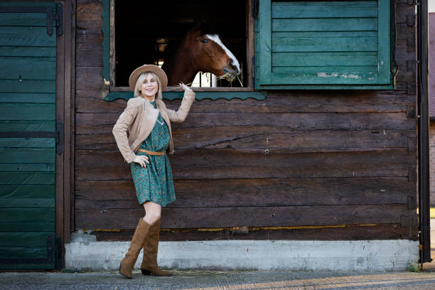 istock beautiful girl in boho style talks to a horse through a window 1393668979