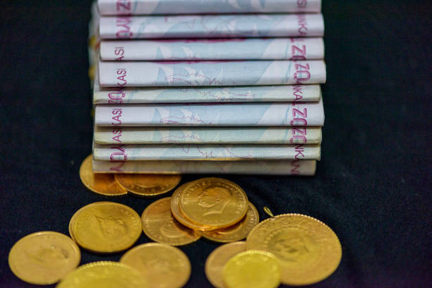 200 Turkish lira and gold coin regularly stand on black background 200 Turkish lira and gold coin regularly stand on black background para birimi stock pictures, royalty-free photos & images