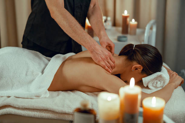 istock Professional masseur man doing back massage for female client at spa center. Relaxation, therapy 1393672186