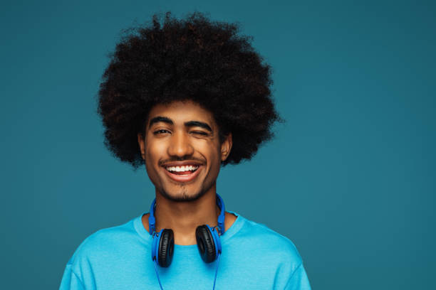 istock African american man with african hairstyle using phone 1393672396