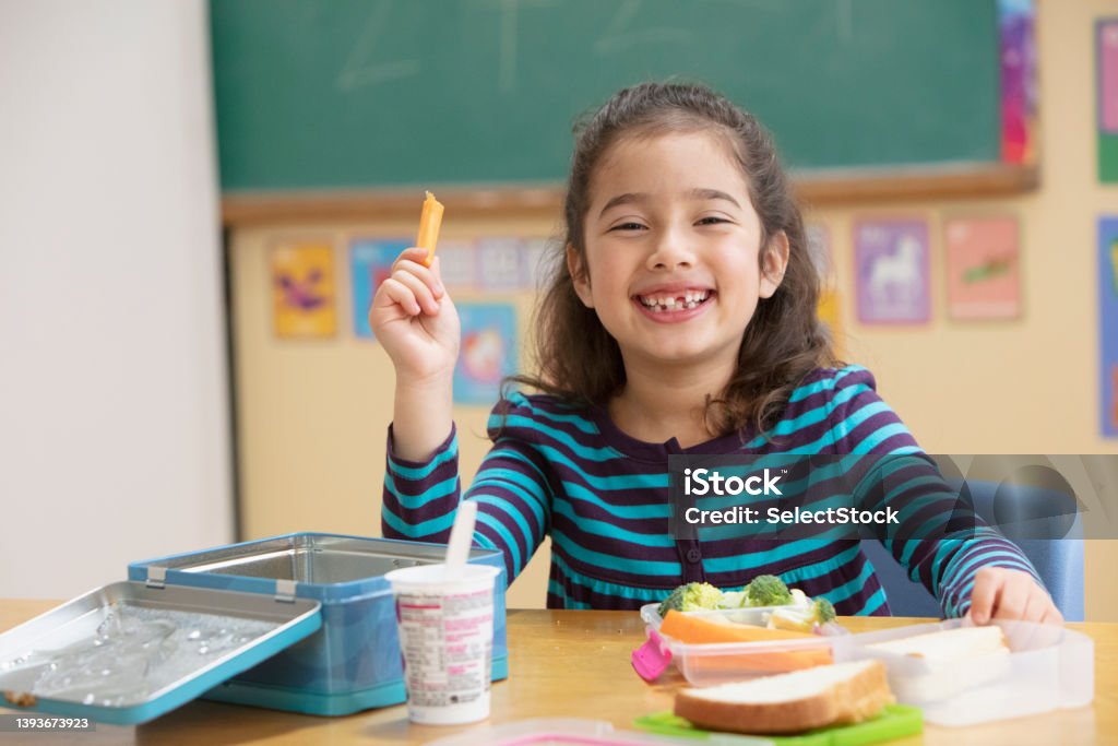 Little girl eating healthy at school Healthy Eating Stock Photo