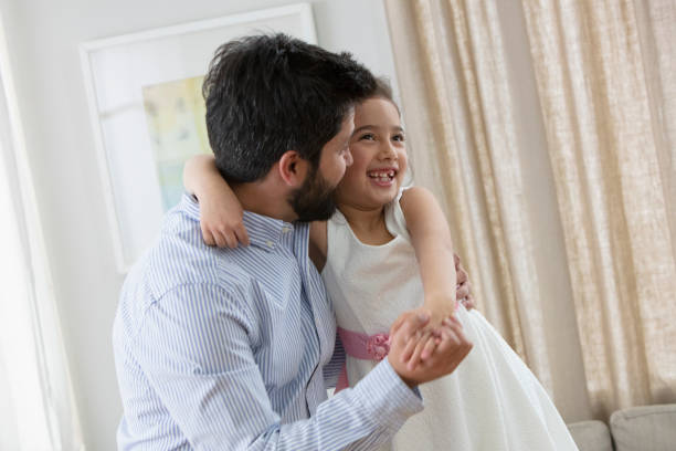 istock father and little daughter dancing 1393673948