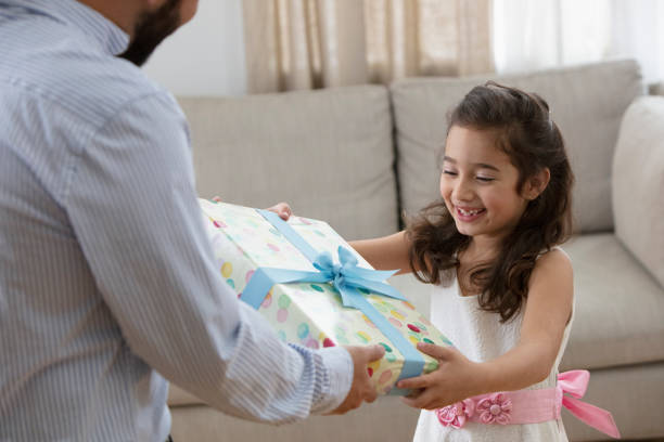 istock little girl receiving a gift 1393674093