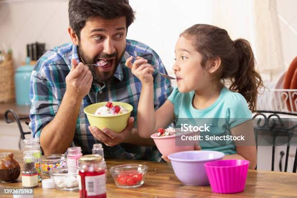 Father And Daughter Putting Sprinkles On Ice Cream Stock Photo - Download Image Now - Ice Cream, Domestic Life, Home Interior