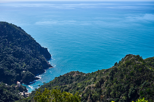 View from above of San Fruttuoso Bay, Doria Tower and the Abbey of San Fruttuoso. The abbey can only be reached by sea or by hiking trails. Genova. Italy.