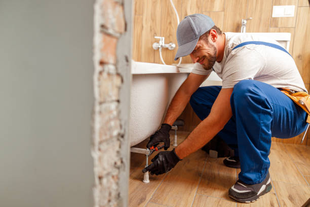 istock Cheerful plumber or technician preparing details for bathtub installation in bathroom 1393677057