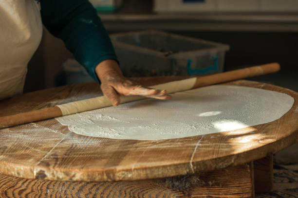 istock Woman's hand rolling dough for pancakes in Antalya, Turkey. SELECTVE FOCUS 1393682787