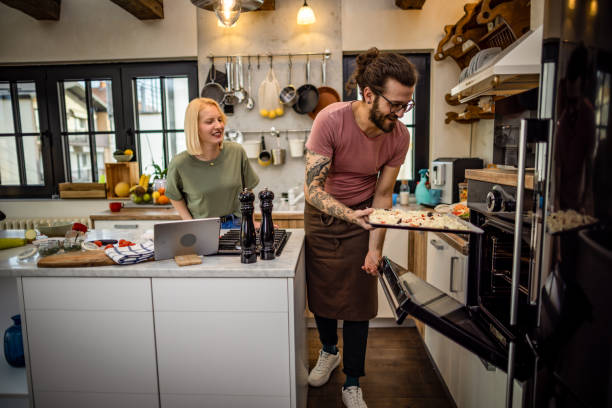 istock Couple preparing dinner at home 1393682797