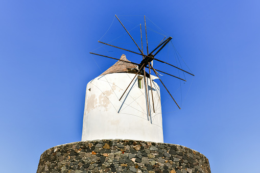Ruins of old abandoned windmill in Emporio village on the south side of Santorni. Cyclades Islands, Greece.