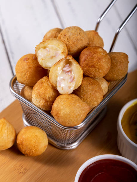 istock Brazilian snacks, fried balls stuffed with ham and cheese 1393686135