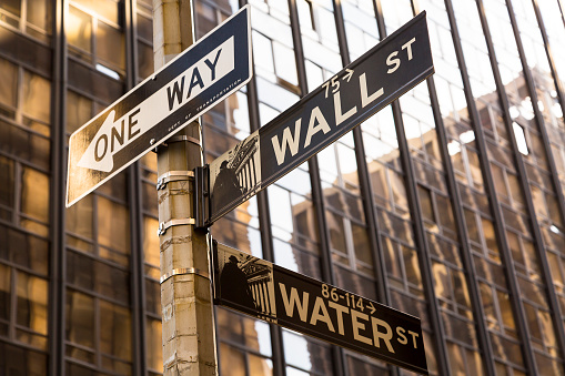 Wall street sign , office building in background, America, USA.
