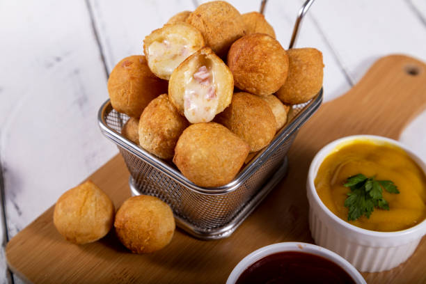istock Brazilian snacks, fried balls stuffed with ham and cheese 1393686227