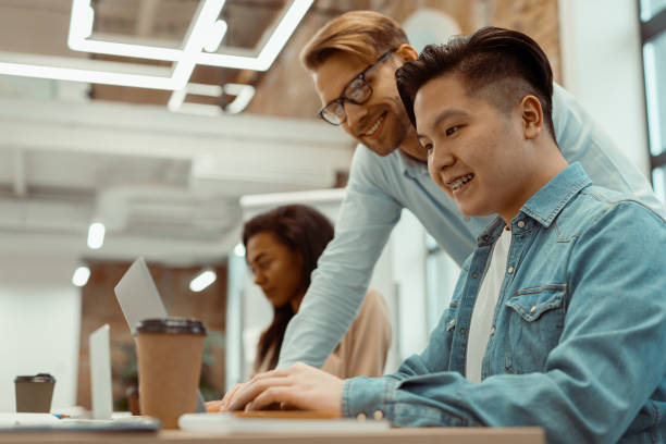 istock Young managers men and woman smiling in office 1393686794