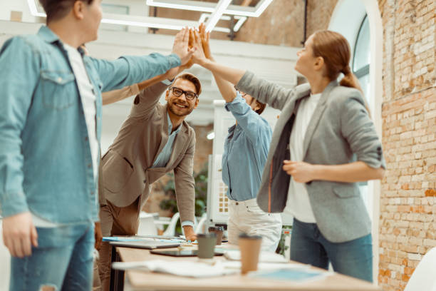 istock Smiling colleagues showing team work in office 1393686854