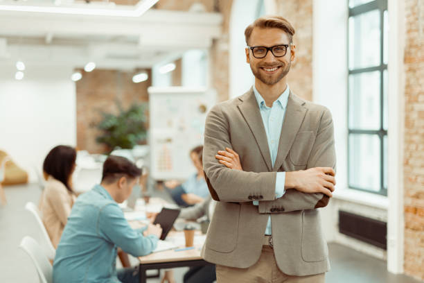 istock Smiling man standing in a coworking space and clasped his hands 1393686858