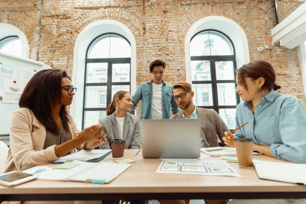istock Young people looking at laptop sreen in the office 1393686898