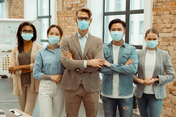 istock Creative business team in face masks looking at camera 1393686905