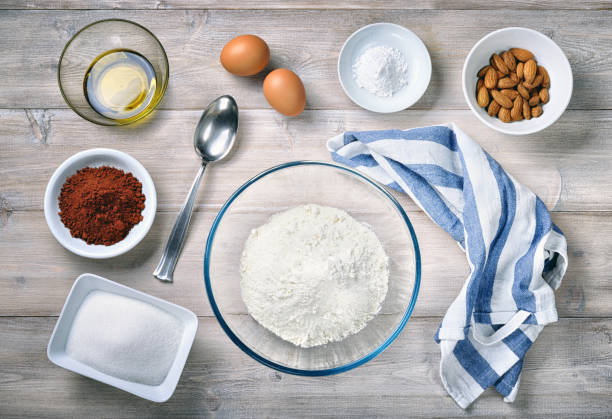 istock Ingredients for cantucci biscuits with almonds, eggs, flour, sugar and cocoa, top view. 1393688502