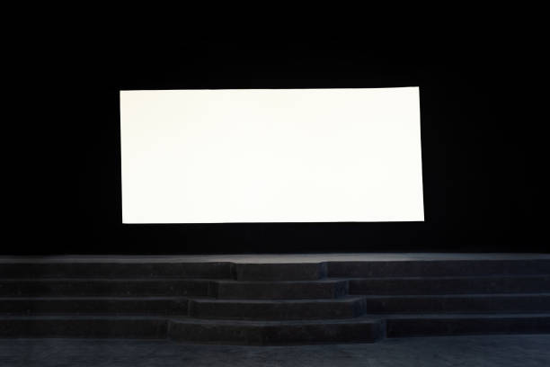 istock White mock-up screen on dark wall at cinema theater stage 1393690390