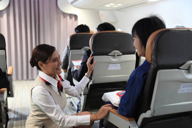 istock air hostess service on plane , flight attendant checking and closing cabin compartment in airplane 1393693945