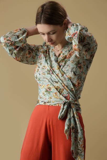istock Woman in floral wrap blouse, studio shot. 1393694823