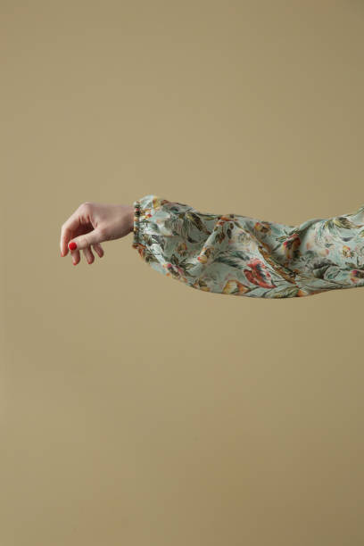 Woman's arm in floral silk blouse Woman's arm in floral silk blouse viscose stock pictures, royalty-free photos & images