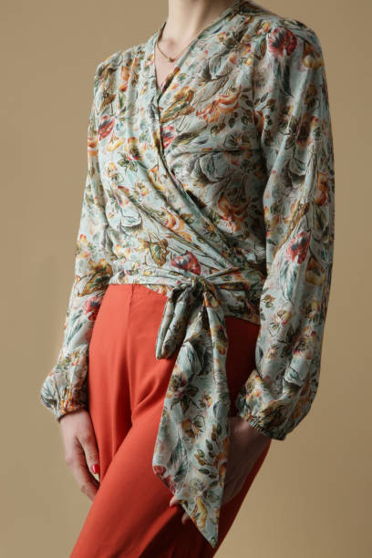 istock Woman in floral wrap blouse, studio shot. 1393694881