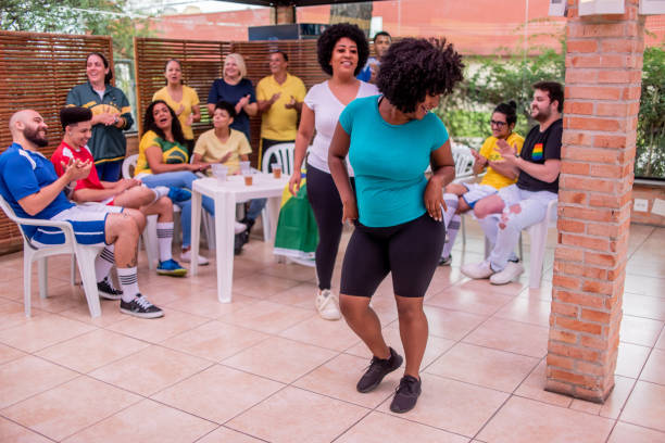 Women dancing samba at a barbecue with friends