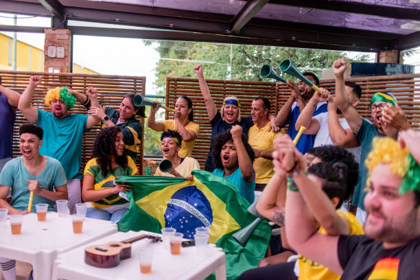 istock Soccer fans cheering for brazil 1393696729