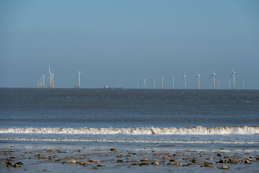 Beaches, waves and distant wind turbines