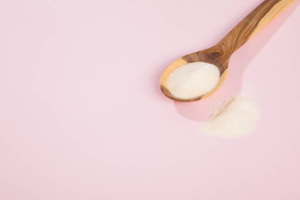 istock Collagen powder on pink background. 1393709539