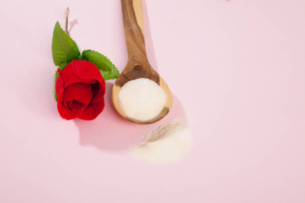 istock Collagen powder on pink background. 1393709548