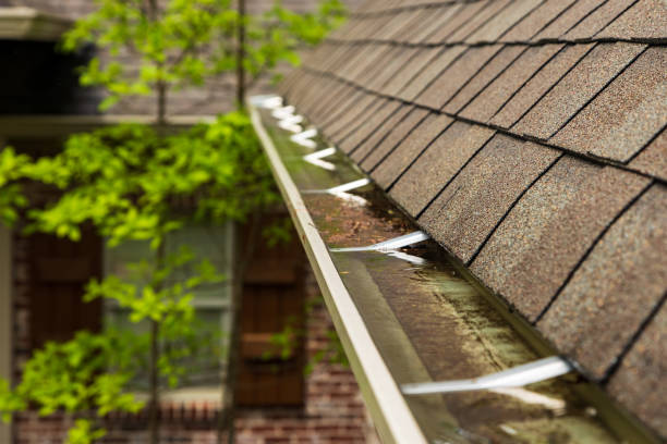 Gutter on home overflowing with water stock photo