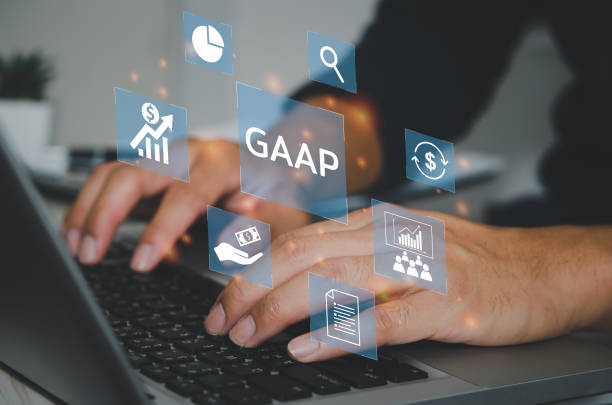istock man hand using laptop virtual screen GAAP Generally Accepted Accounting Principles icons and symbols. Business financial concept. 1393710680