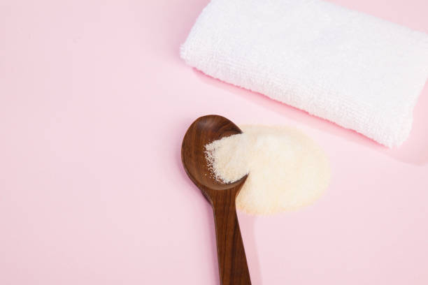 istock Collagen powder on pink background. 1393711259