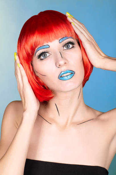 istock Female in red wig and in comic  pop art make-up style on blue background 1393714584