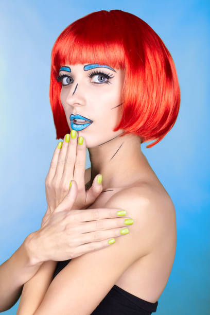 istock Female in red wig and in comic pop art make-up style on blue background 1393714616