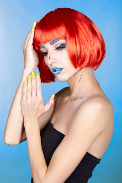 istock Female in red wig and in comic pop art make-up style on blue background 1393714617