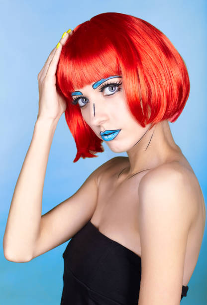 istock Female in red wig and in comic pop art make-up style on blue background 1393714618
