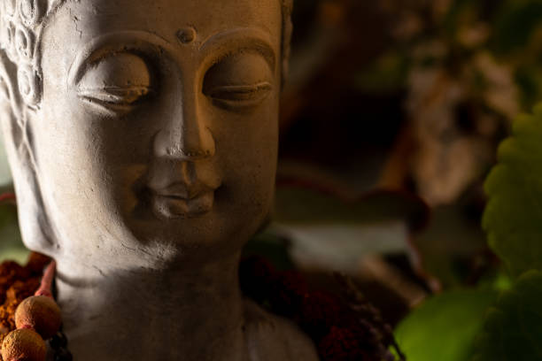 istock buddha statue image on altar with candles and plants 1393714643