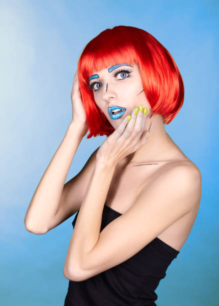 istock Female in red wig and in comic pop art make-up style on blue background 1393714654