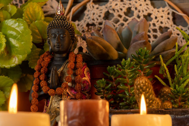 istock buddha statue image on altar with candles and plants 1393714655
